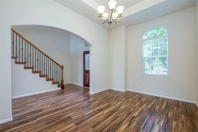 wooden floor in an empty room with a window