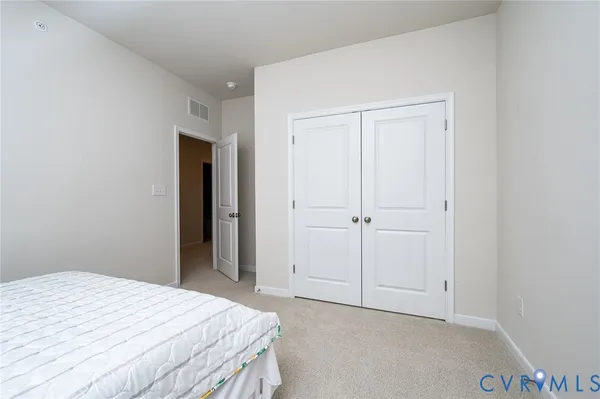 a bedroom with a bed and a wall painting