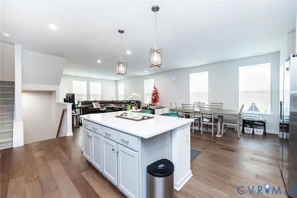 a kitchen with kitchen island a refrigerator a stove a sink and a chairs
