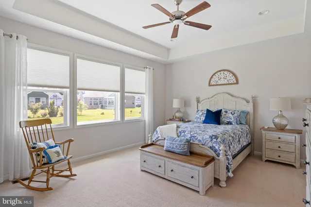 a bedroom with a bed chair and a window