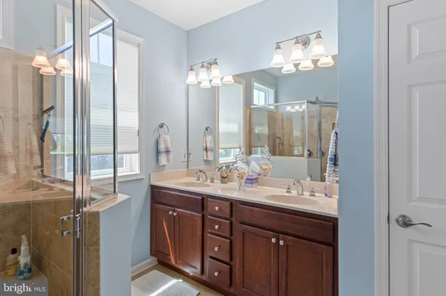 a bathroom with a glass shower door and a window