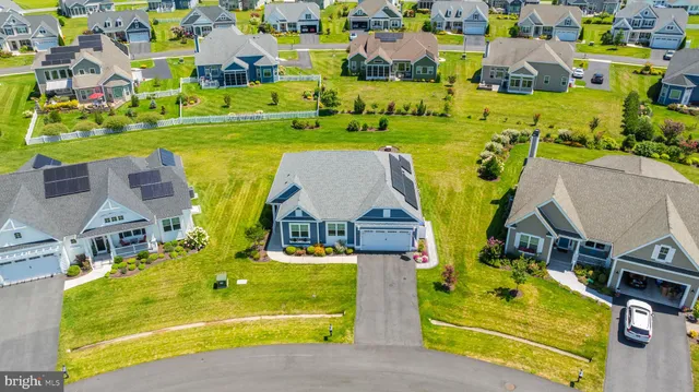 an aerial view of residential houses with outdoor space and swimming pool
