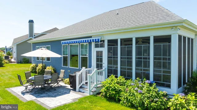 a front view of a house with garden and porch