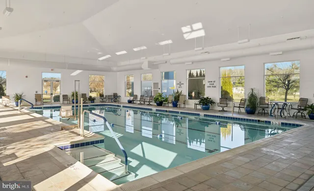 a sign board with a small yard and a wooden fence