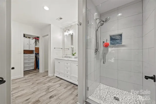 a bathroom with a shower sink and mirror