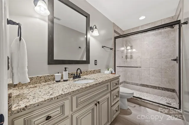 a bathroom with a granite countertop sink mirror and double