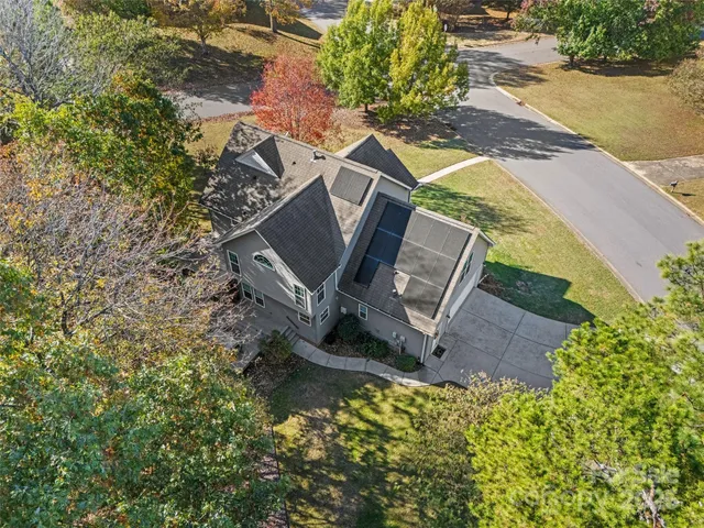 an aerial view of a house with a yard and lake view