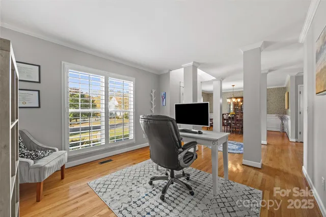 a view of a workspace with furniture and a window