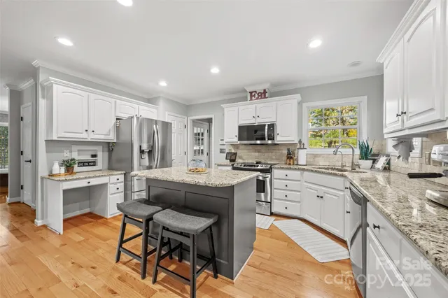 a kitchen that has a lot of cabinets in it and appliances