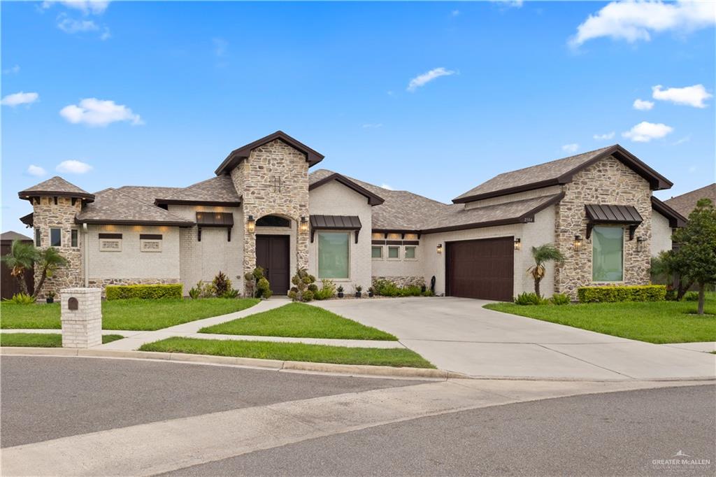 2504 Tulip Street Mission, TX 78574 - Photo 1 of 26 a front view of a house with a yard and garage