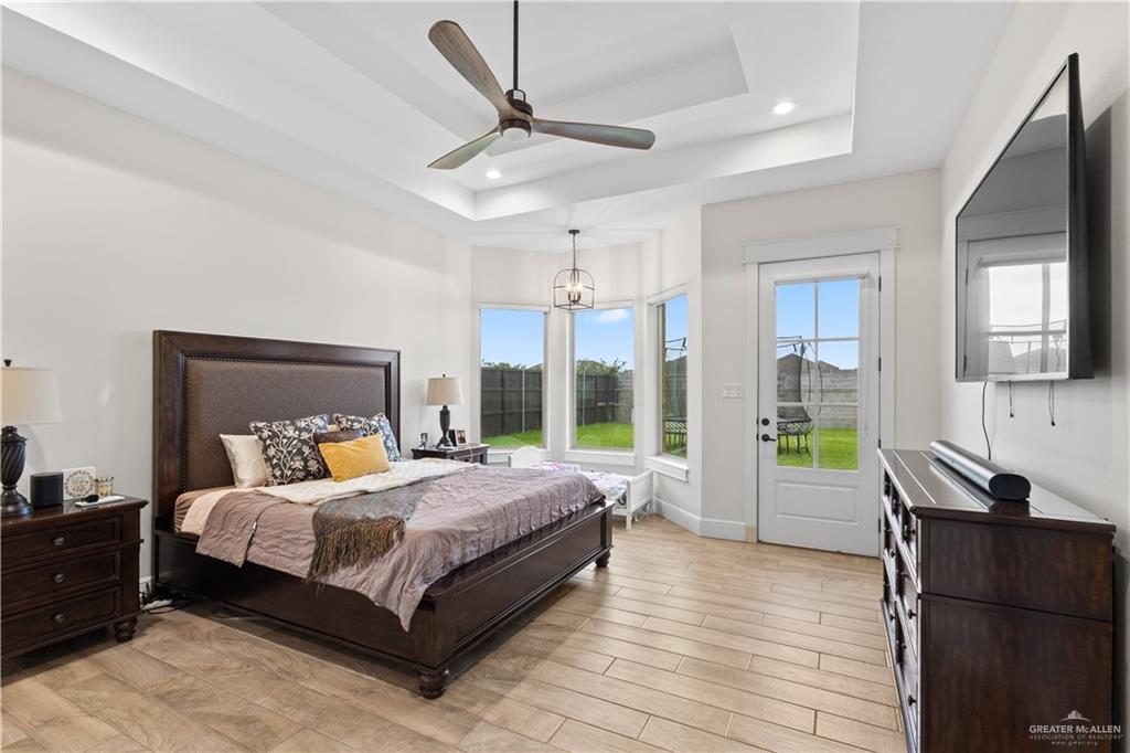 2504 Tulip Street Mission, TX 78574 - Photo 11 of 26 a bedroom with a bed and wooden floor
