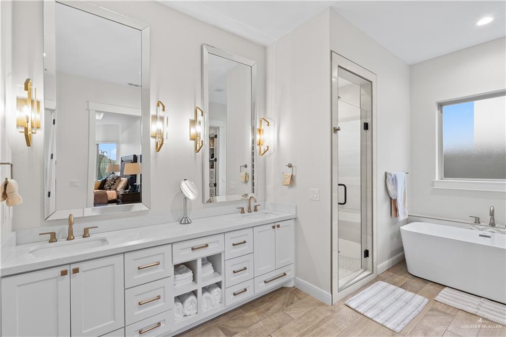 2504 Tulip Street Mission, TX 78574 - Photo 12 of 26 a spacious bathroom with a double vanity sink mirror and bathtub