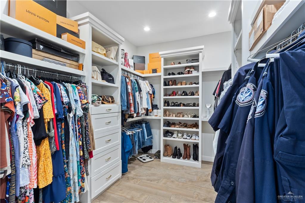 2504 Tulip Street Mission, TX 78574 - Photo 14 of 26 a view of walk in closet with clothes and shoes