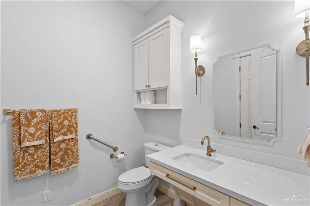 2504 Tulip Street Mission, TX 78574 - Photo 17 of 26 a bathroom with a sink and a toilet