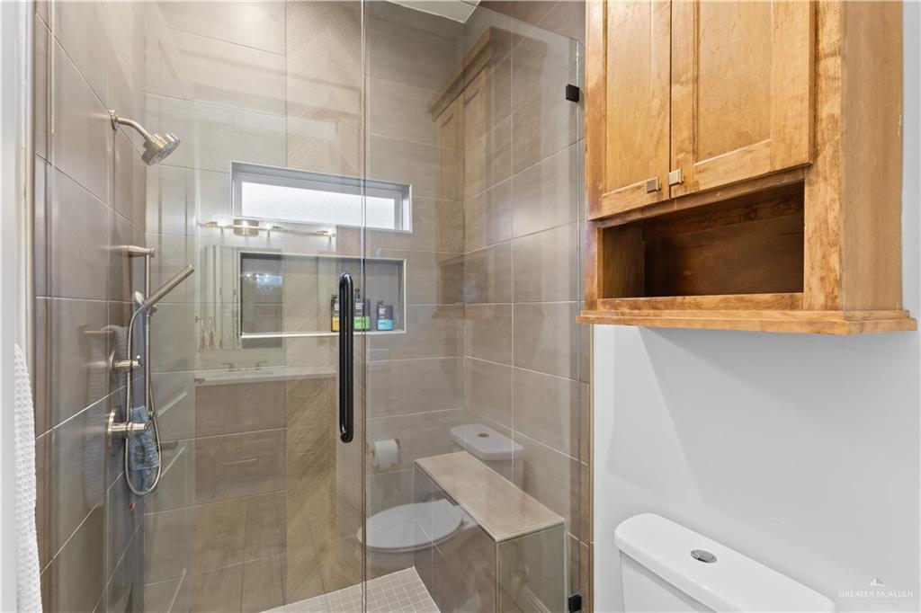 2504 Tulip Street Mission, TX 78574 - Photo 19 of 26 a bathroom with a granite countertop sink and a mirror