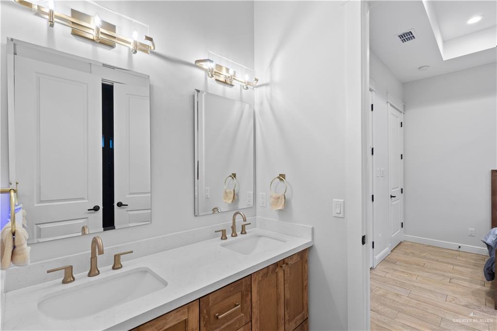 2504 Tulip Street Mission, TX 78574 - Photo 20 of 26 a bathroom with a sink double vanity and a mirror