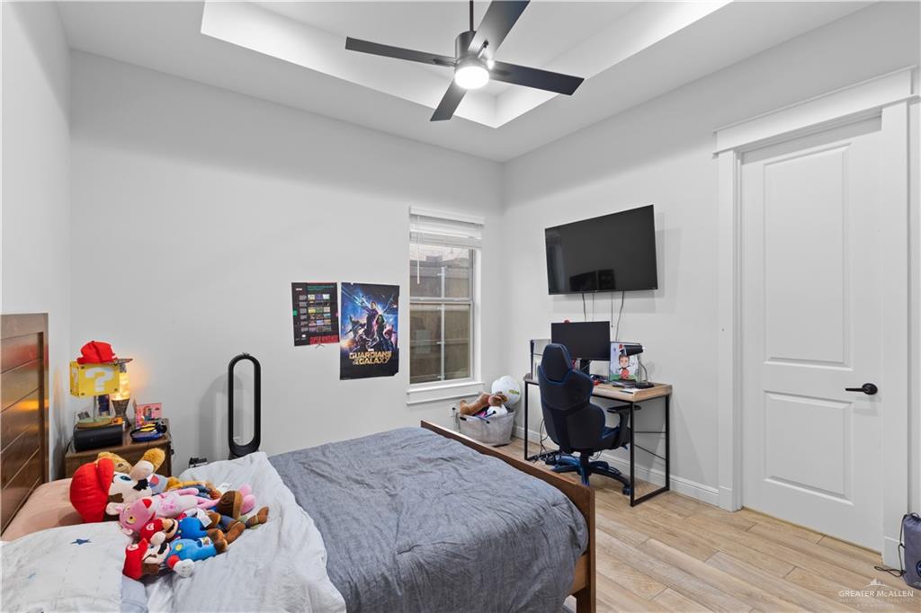 2504 Tulip Street Mission, TX 78574 - Photo 21 of 26 a bedroom with a bed and a flat screen tv