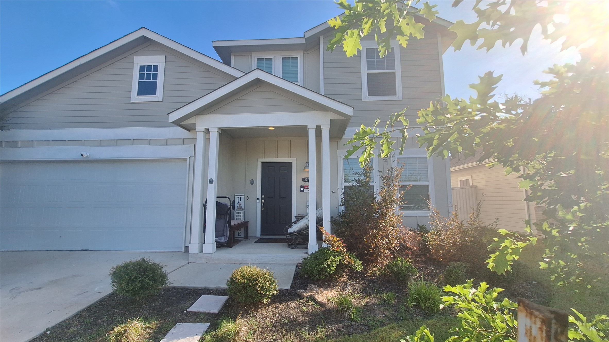 A welcoming facade with a covered entry and attached garage provides appealing curb appeal.