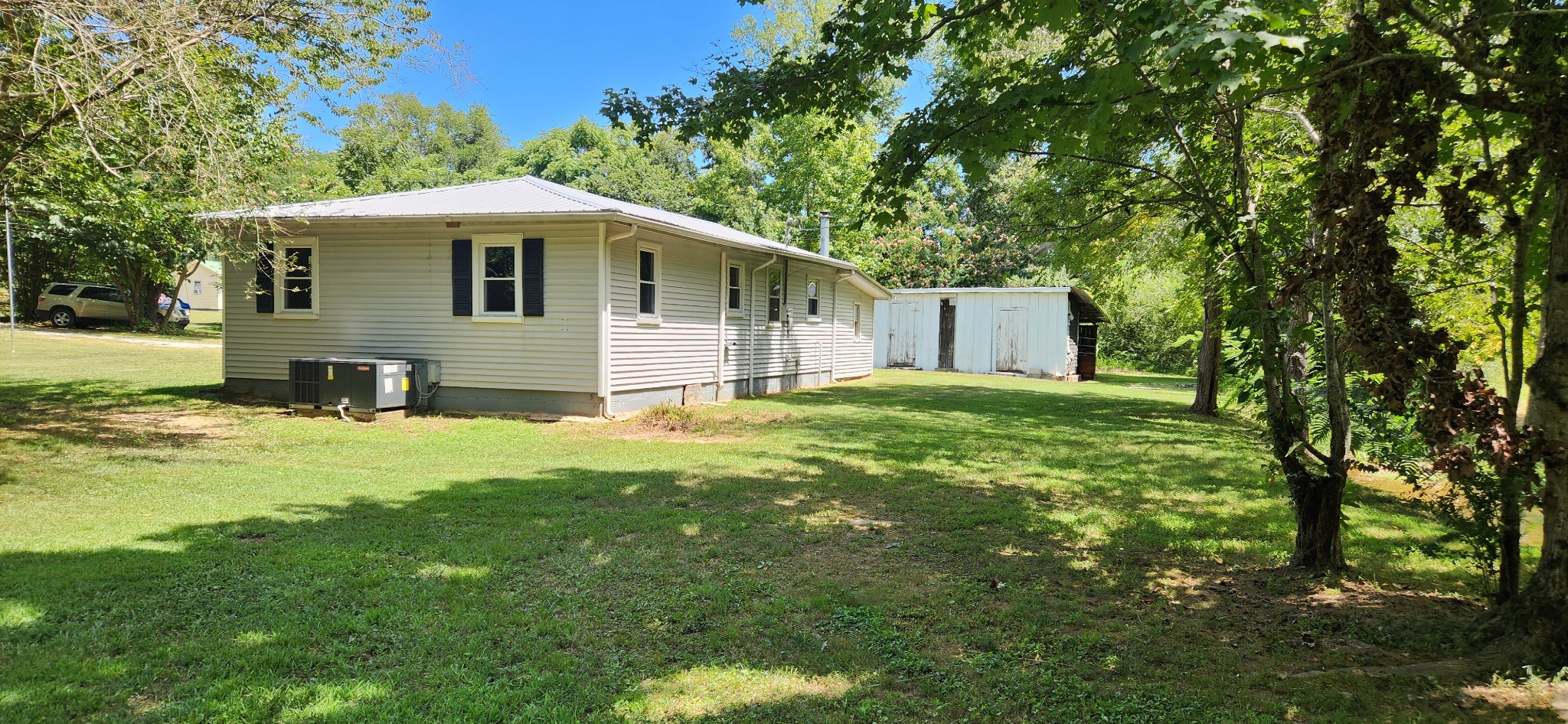 259 Brushy Road Centerville, TN 37033 - Photo 5 of 17 Looking from creek to back side of home. HVAC unit is new.