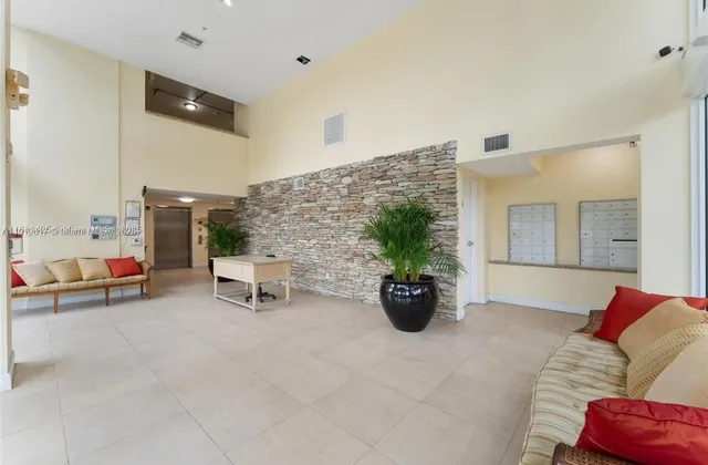a living room with furniture and flowers