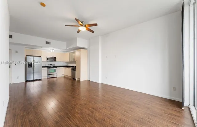 a view of a kitchen with a dishwasher cabinets and a wooden floor