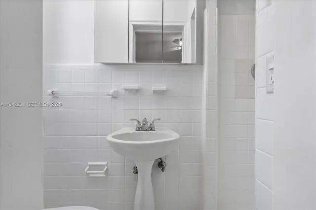 an empty room with wooden floor closet and windows