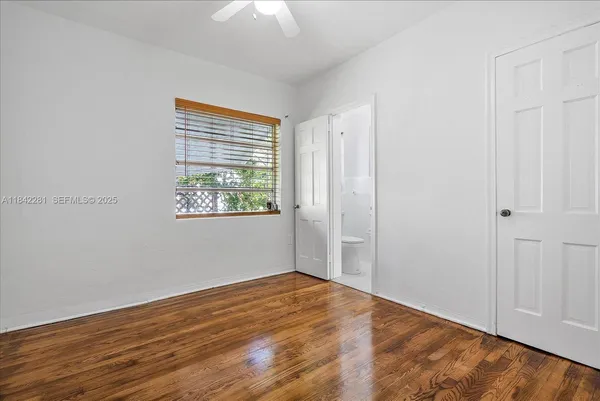 a view of an empty room with wooden floor