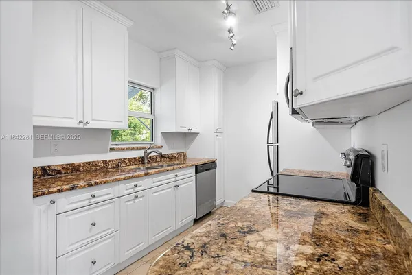 a kitchen with stainless steel appliances granite countertop a stove and a refrigerator