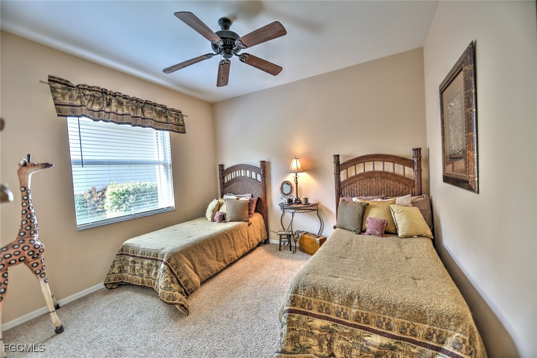 15022 Balmoral Loop Fort Myers, FL 33919 - Photo 13 of 27 a spacious bedroom with two beds and a window