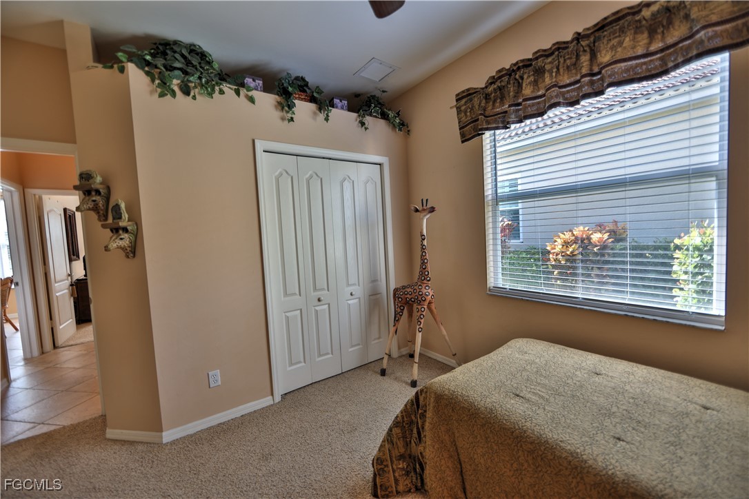 15022 Balmoral Loop Fort Myers, FL 33919 - Photo 14 of 27 a bedroom with a bed and a window