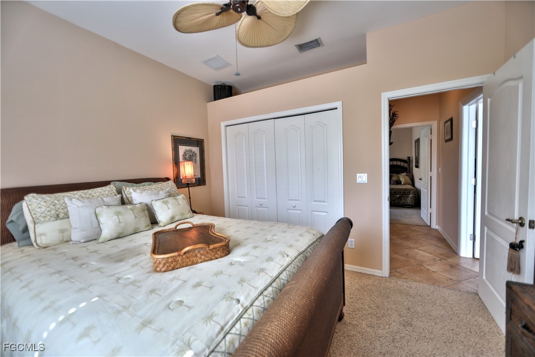 15022 Balmoral Loop Fort Myers, FL 33919 - Photo 15 of 27 a bed room with a bed and a chandelier
