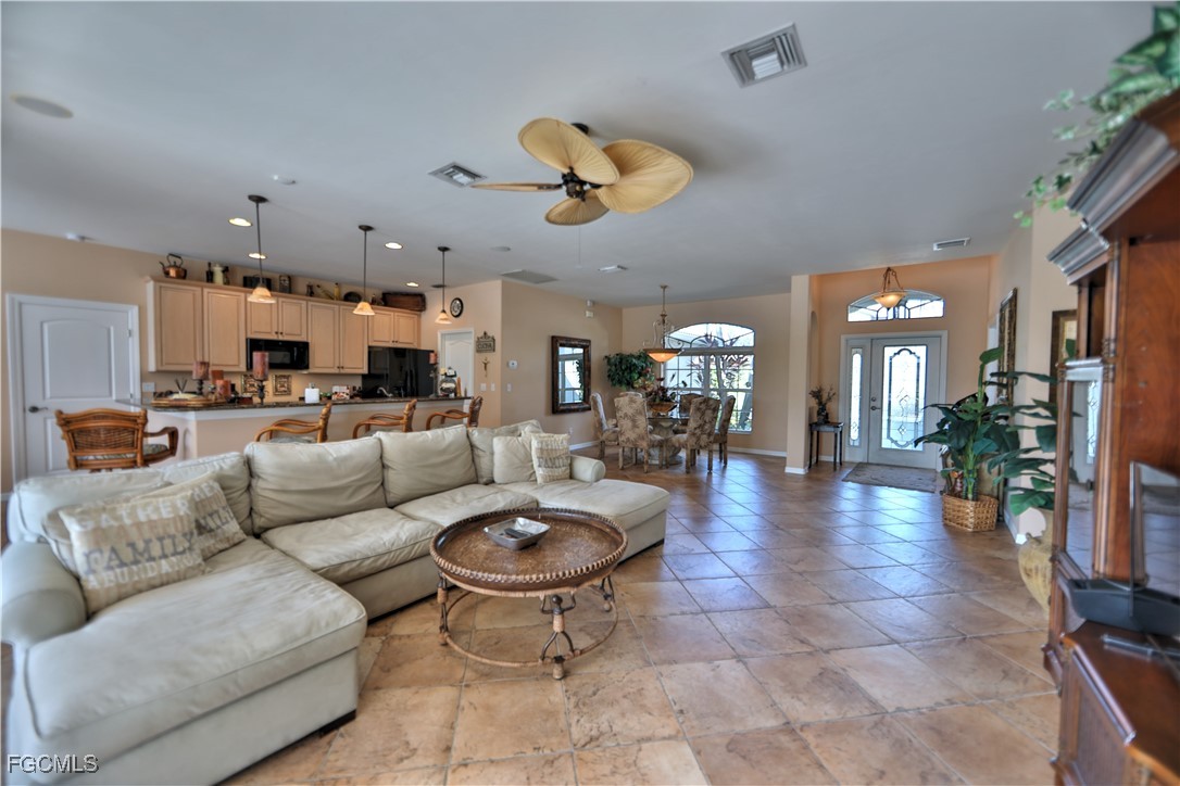 15022 Balmoral Loop Fort Myers, FL 33919 - Photo 17 of 27 a living room with furniture kitchen view and a large window