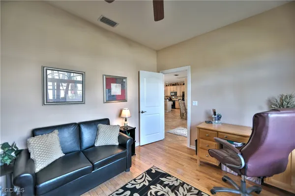 a living room with furniture and a wooden floor