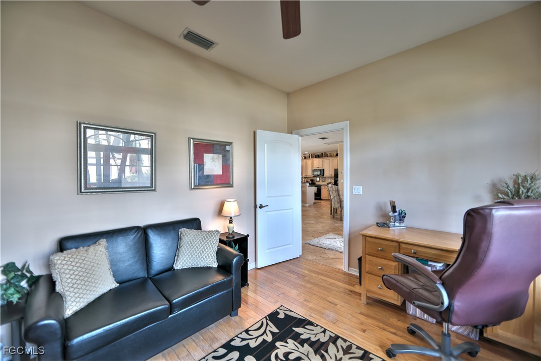 15022 Balmoral Loop Fort Myers, FL 33919 - Photo 21 of 27 a living room with furniture and a wooden floor