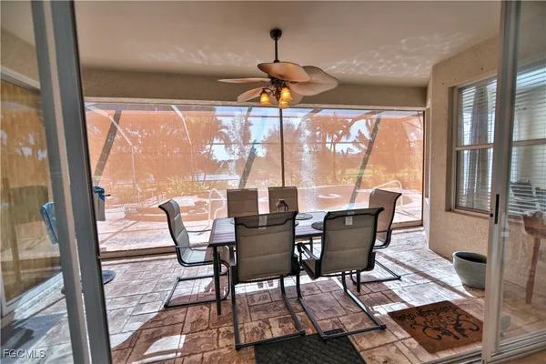 a dining room with furniture wooden floor and a chandelier