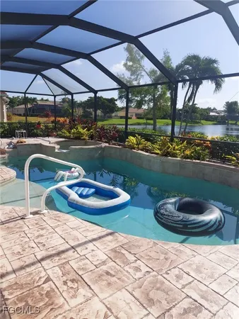 a view of a patio with table and chairs under an umbrella