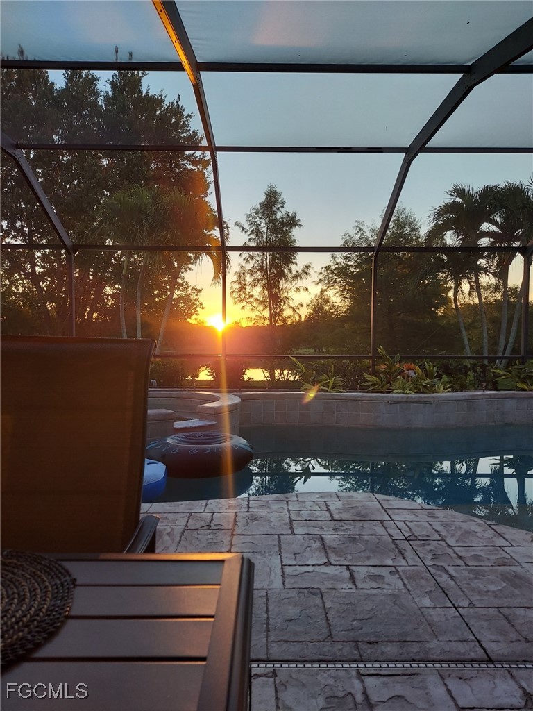 15022 Balmoral Loop Fort Myers, FL 33919 - Photo 6 of 27 a view of a patio with table and chairs next to a yard
