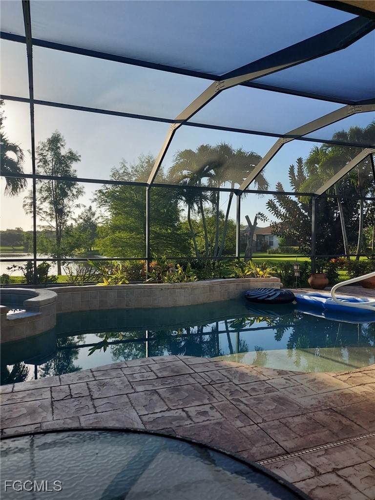 15022 Balmoral Loop Fort Myers, FL 33919 - Photo 7 of 27 a view of a lake with a table and chairs