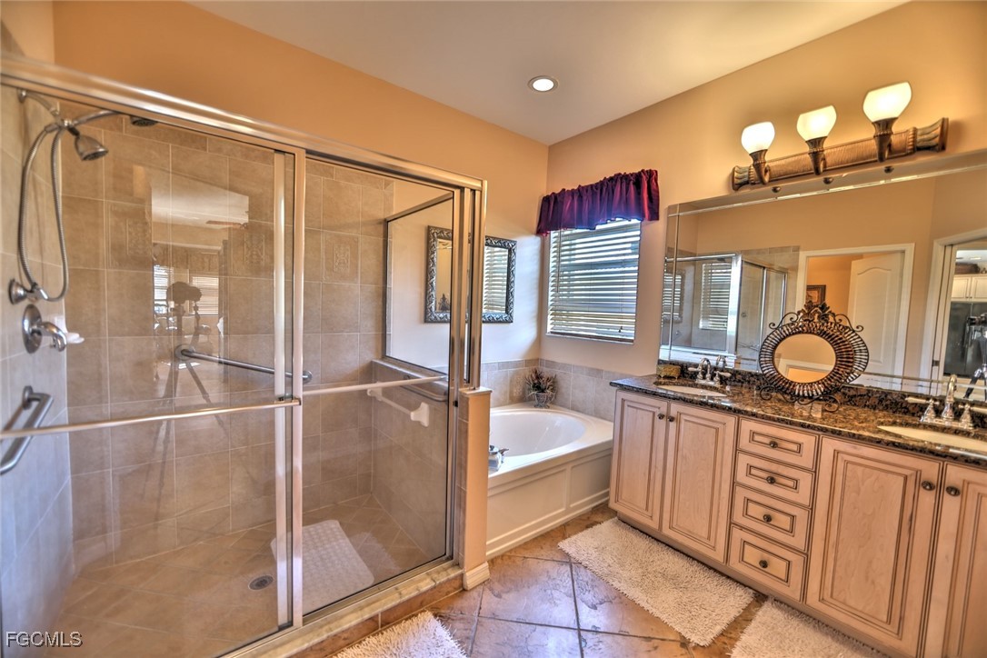 15022 Balmoral Loop Fort Myers, FL 33919 - Photo 9 of 27 a spacious bathroom with a tub sink and mirror