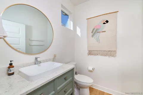 a bathroom with a sink a toilet and a mirror