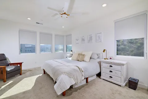 a bedroom with a large bed and a window