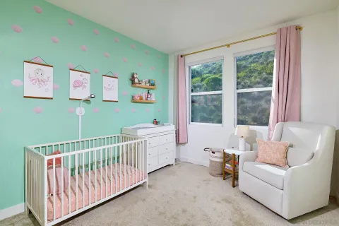 a bedroom with furniture and a large window