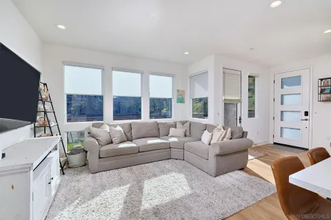 a living room with furniture and large window
