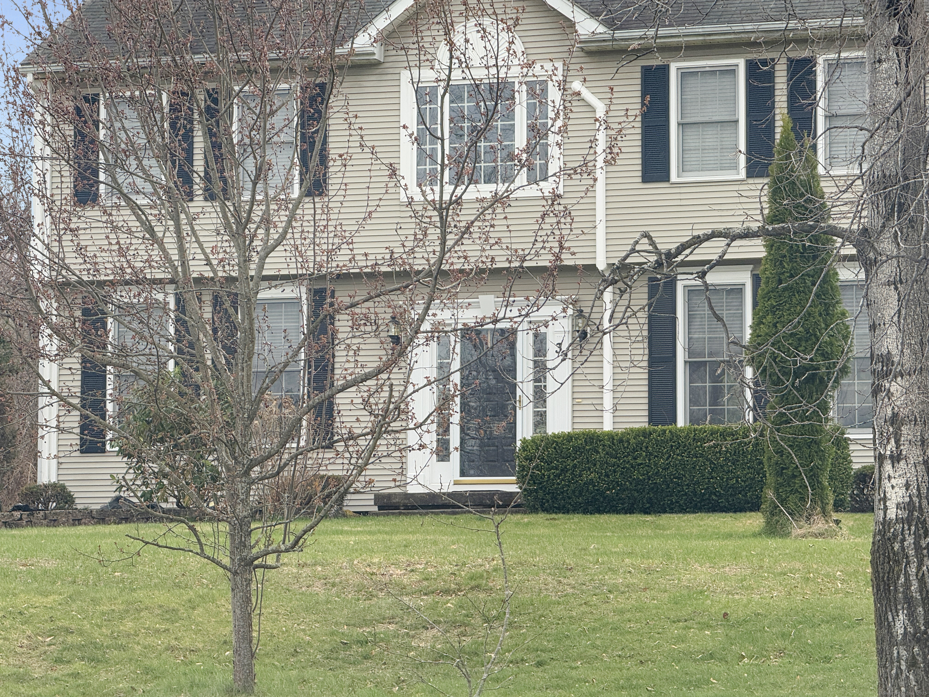 39 Ridge Boulevard East Granby, CT 06026 - Photo 6 of 8 a front view of a house with a yard