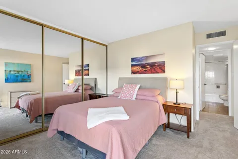 a bedroom with a bed window and a couch