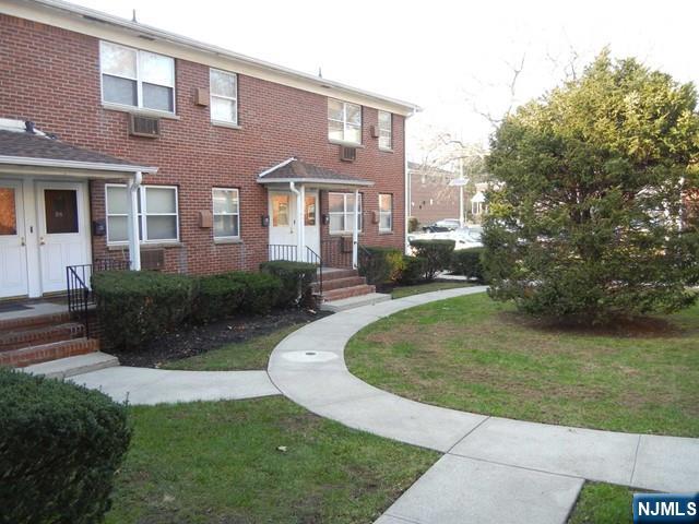 401 West Madison Avenue, Unit 7 Dumont, NJ 07628 - Photo 2 of 15 a front view of a house with a yard