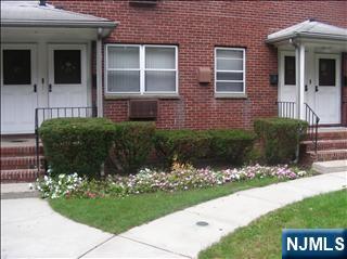 401 West Madison Avenue, Unit 7 Dumont, NJ 07628 - Photo 4 of 15 a front view of a house with a yard and a garden