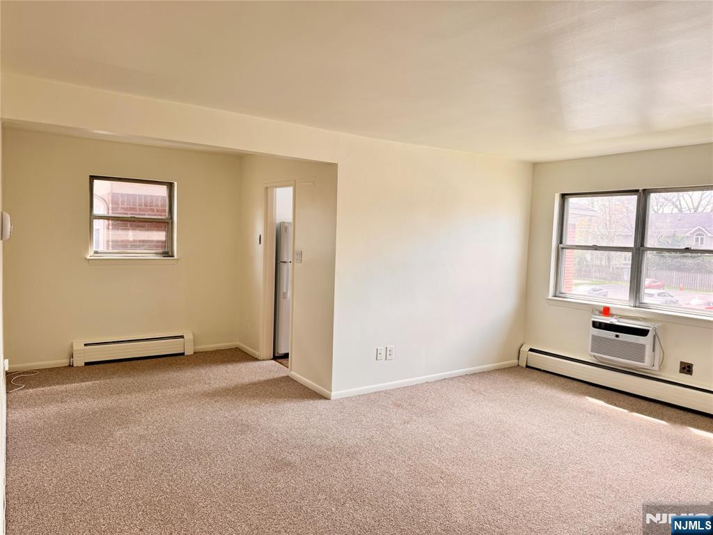 401 West Madison Avenue, Unit 7 Dumont, NJ 07628 - Photo 6 of 15 an empty room with windows