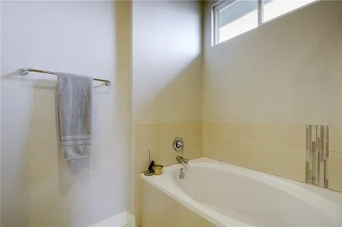 a bedroom with a bed a mirror and a window
