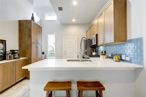 a kitchen with a sink cabinets and window